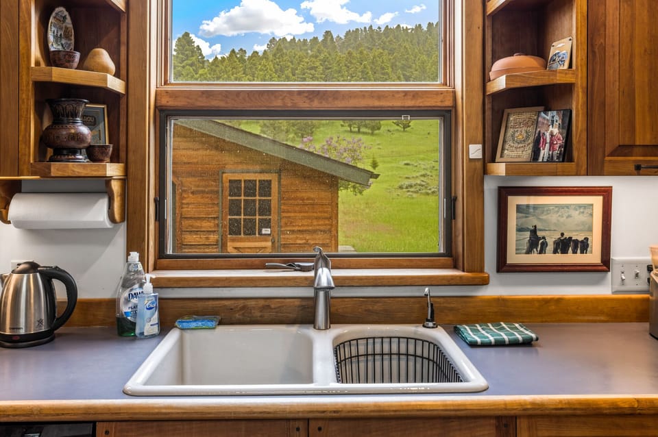 Full kitchen with plenty of cookware and utensils.