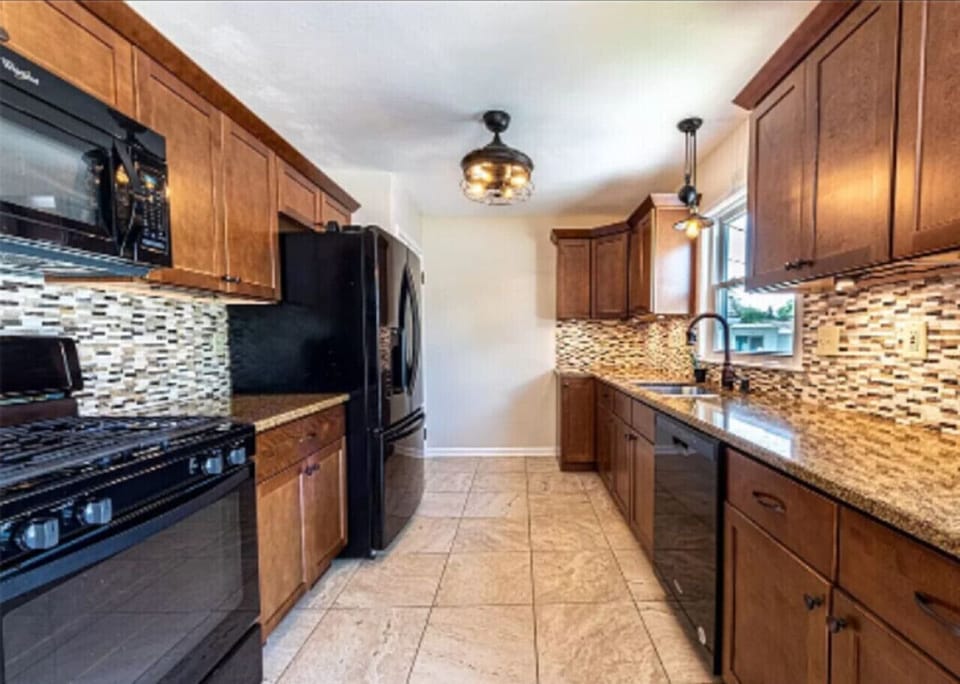 Fully stocked kitchen with all major appliances including full size refrigerator, gas stove and oven, dishwasher and dining for 12.
