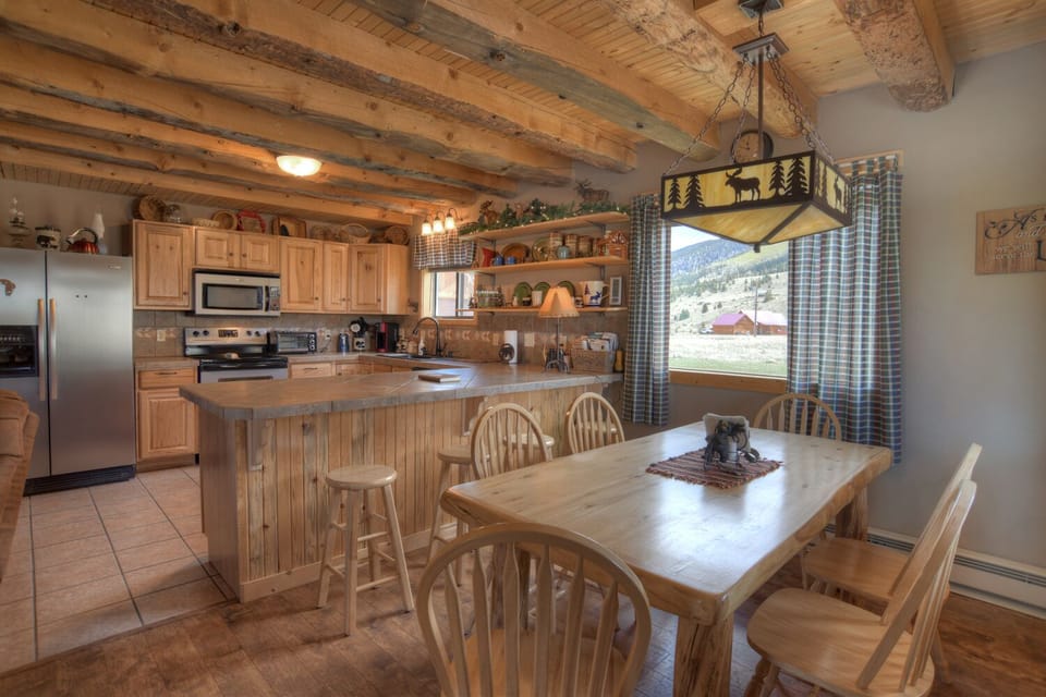 The fully stocked kitchen has a dining area that will seat ten between the table and bar.