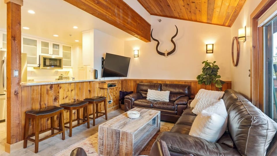 The open concept great room with cozy seating after a long day on the slopes. The living room comes with an HDTV with Apple TV for streaming.