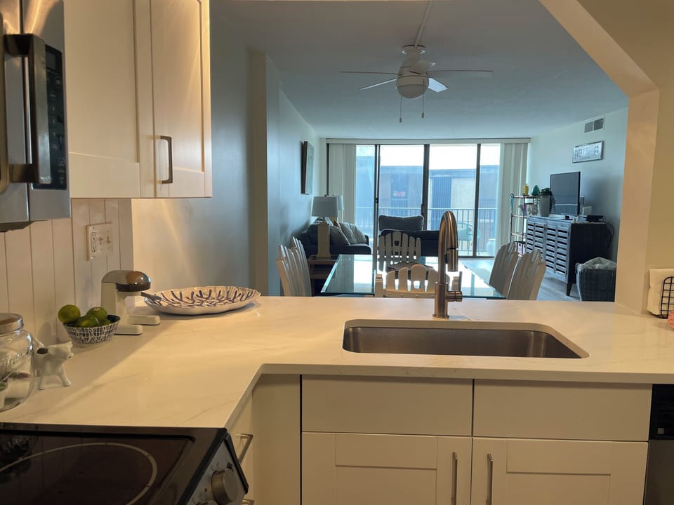 Kitchen opens to a view of dining area and living room