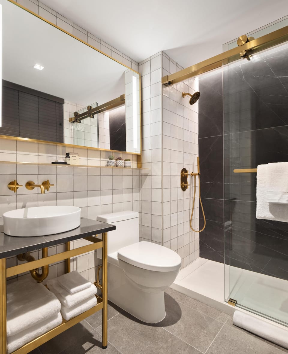 Shower, designer toiletries, hair dryer, bathrobes