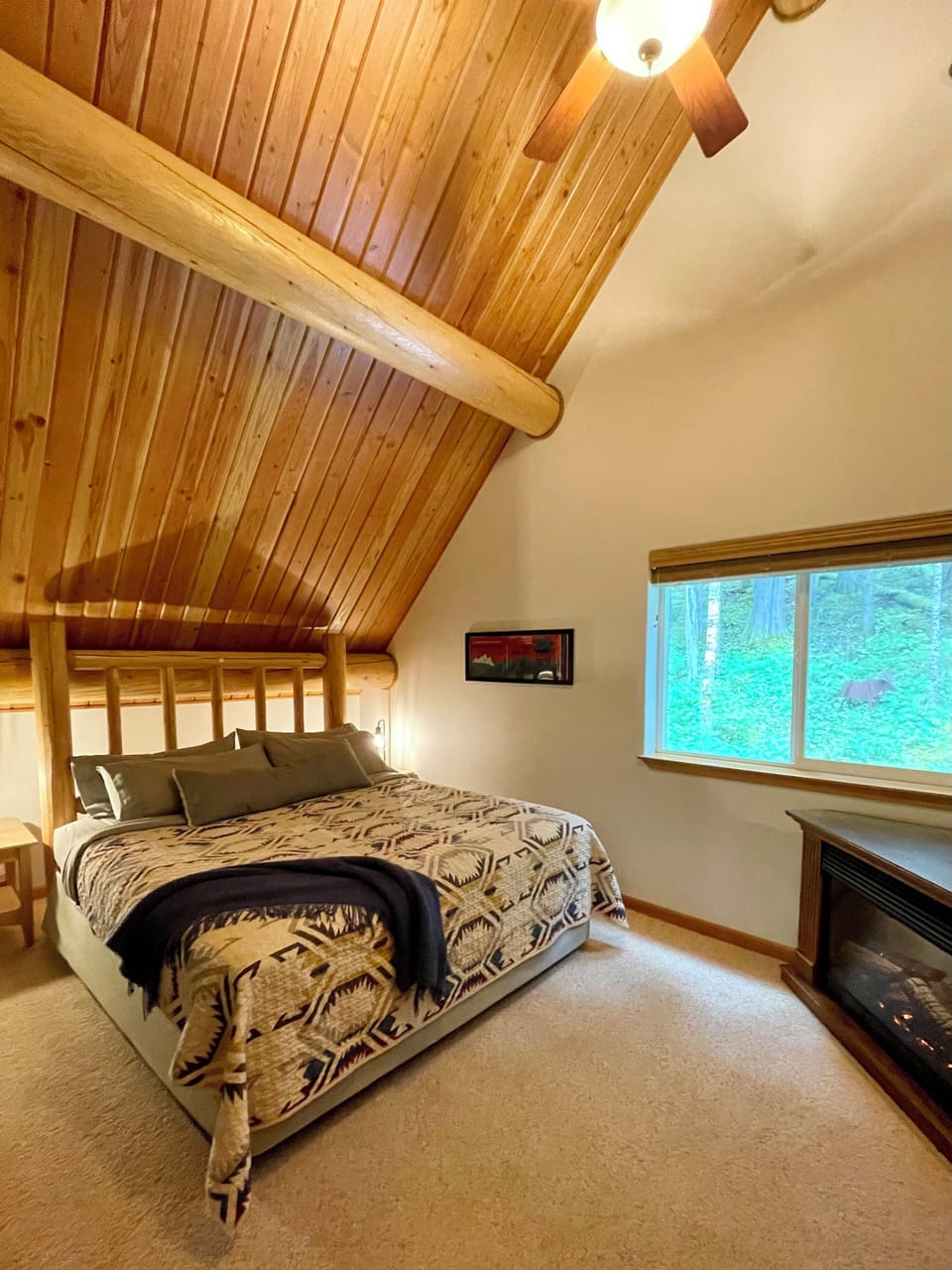 Upstairs primary suite has King bed, private 3/4 bath, walk in closet, & fan. 