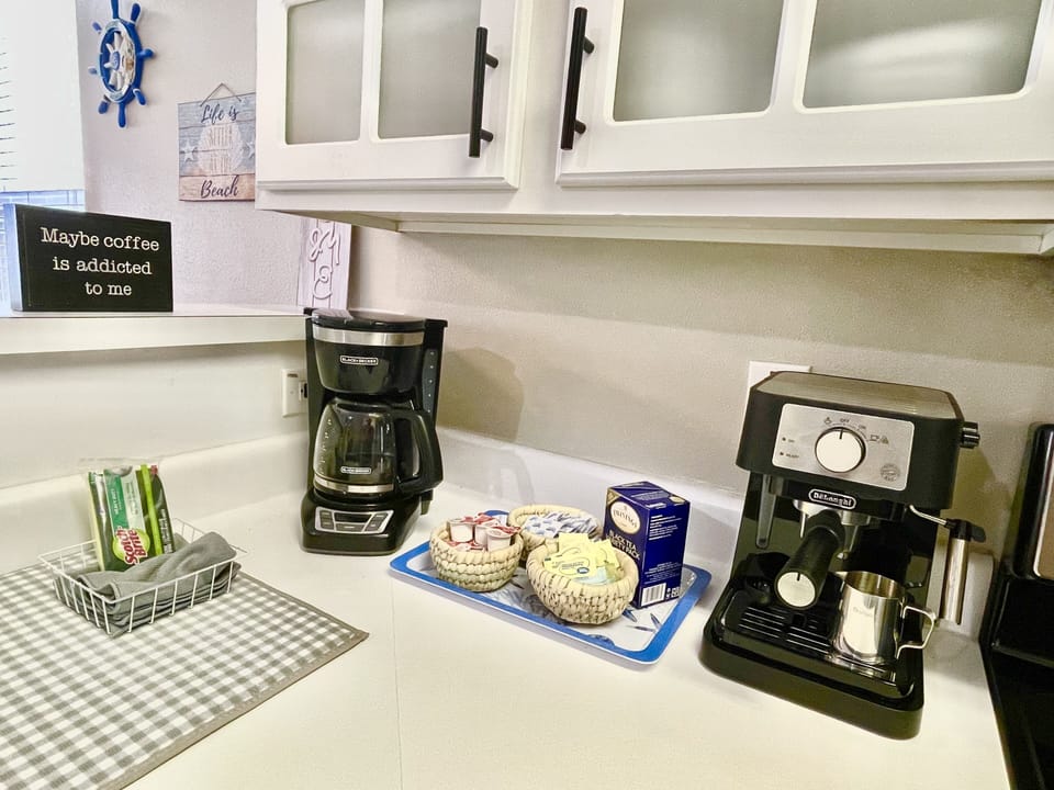 Drip Coffee Maker with complimentary sugar, cream, tea, and sweetners