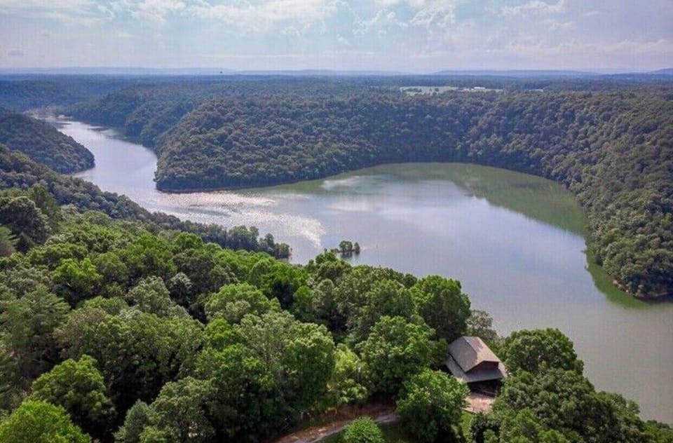 Aerial view.  Tucked in between trees and water.