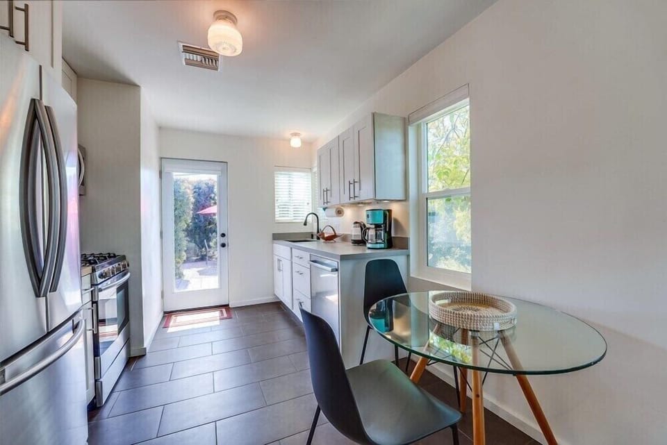 The dining table and kitchen as seen from the living room.