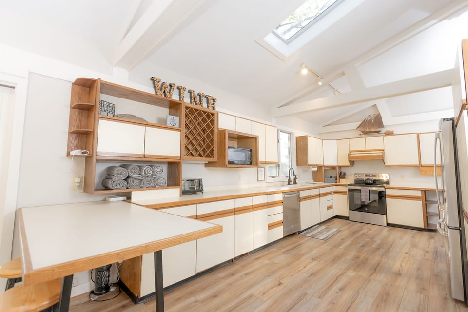 Spacious open-concept kitchen.  Cookware, flatware, dishes, and small appliances provided.