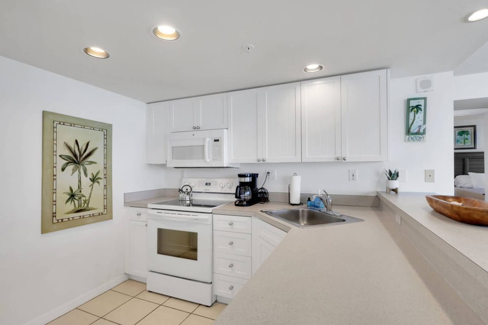 The open kitchen contains a full size refridgerator/freezer, oven, dishwasher and microwave.