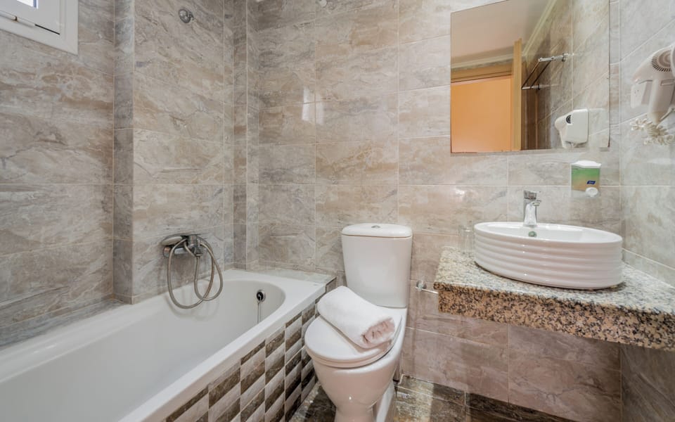 Bathtub, hair dryer, towels, soap