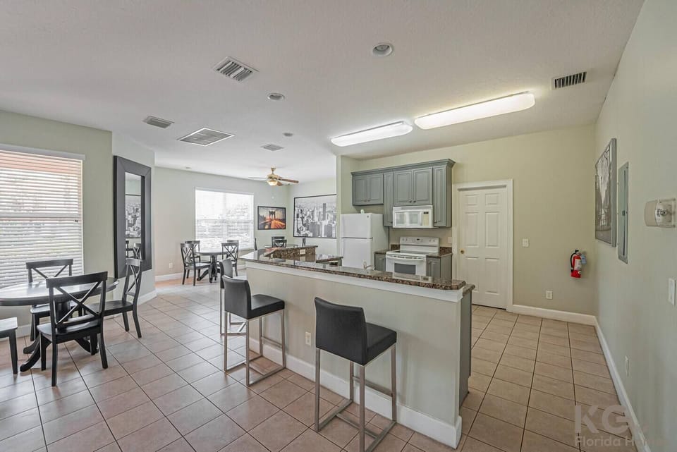 Club house shared kitchen with fridge, oven, microwave and bar.
