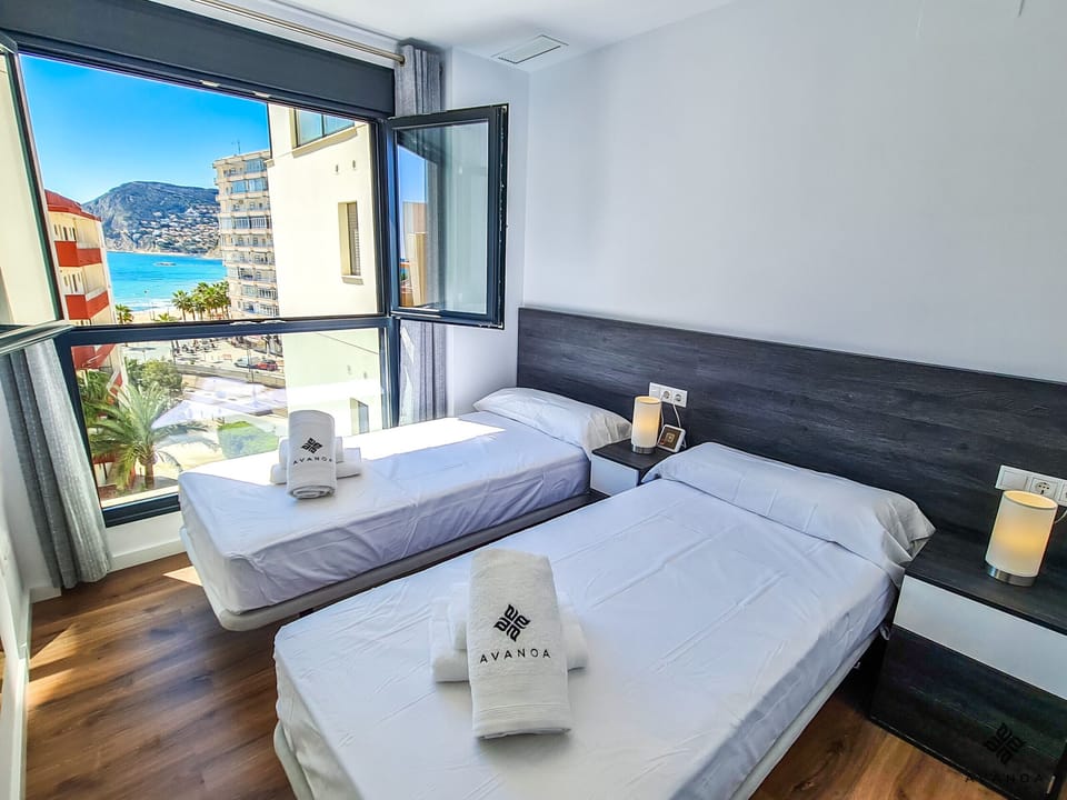 Bedroom with two single beds and incredible sea views.