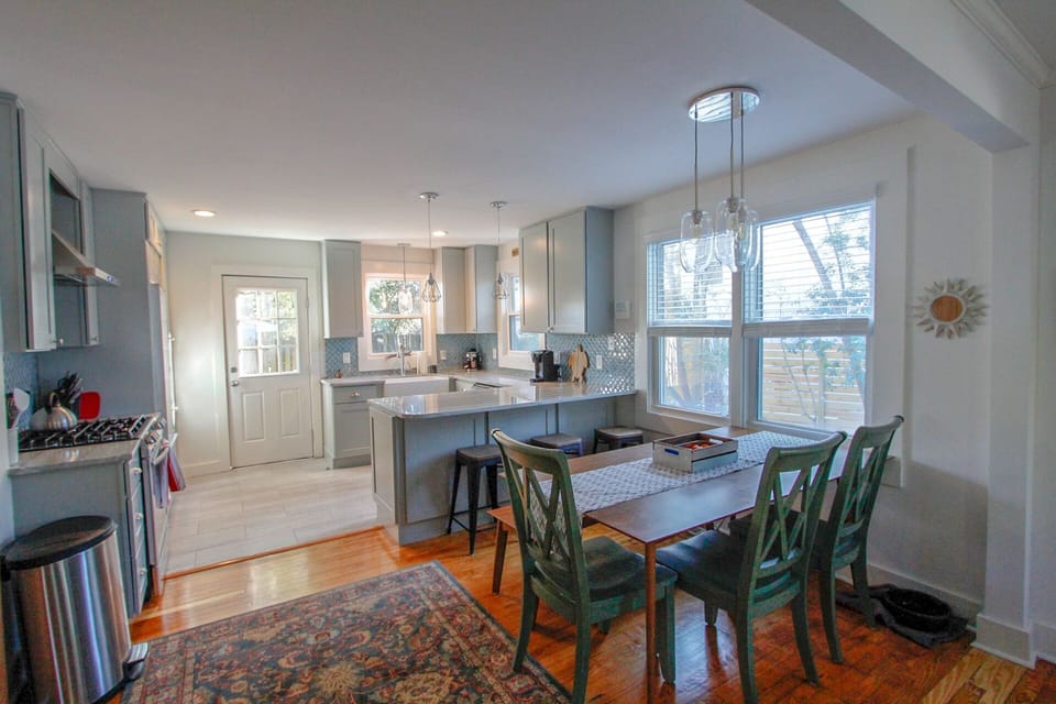 Beautiful Kitchen with stone counter-tops, bar stools and dining
