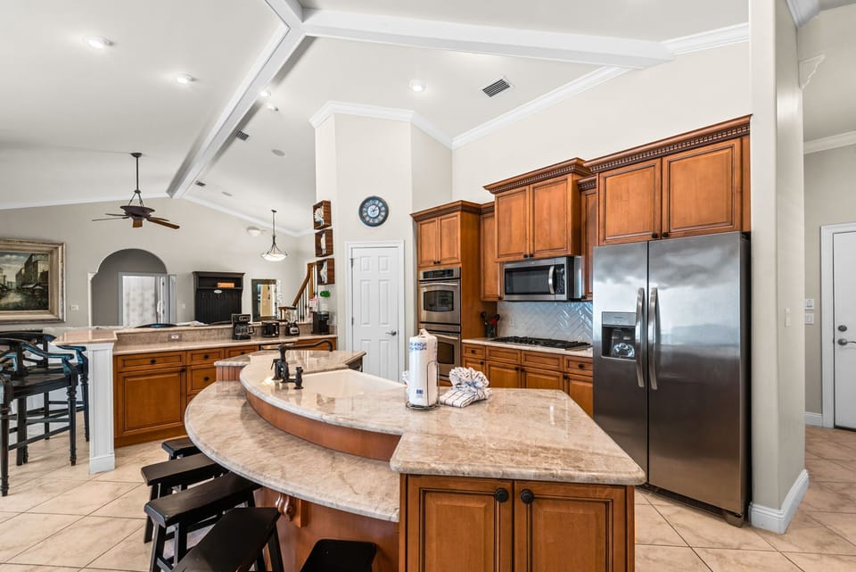 The kitchen features granite counters, stainless appliances, and an open layout