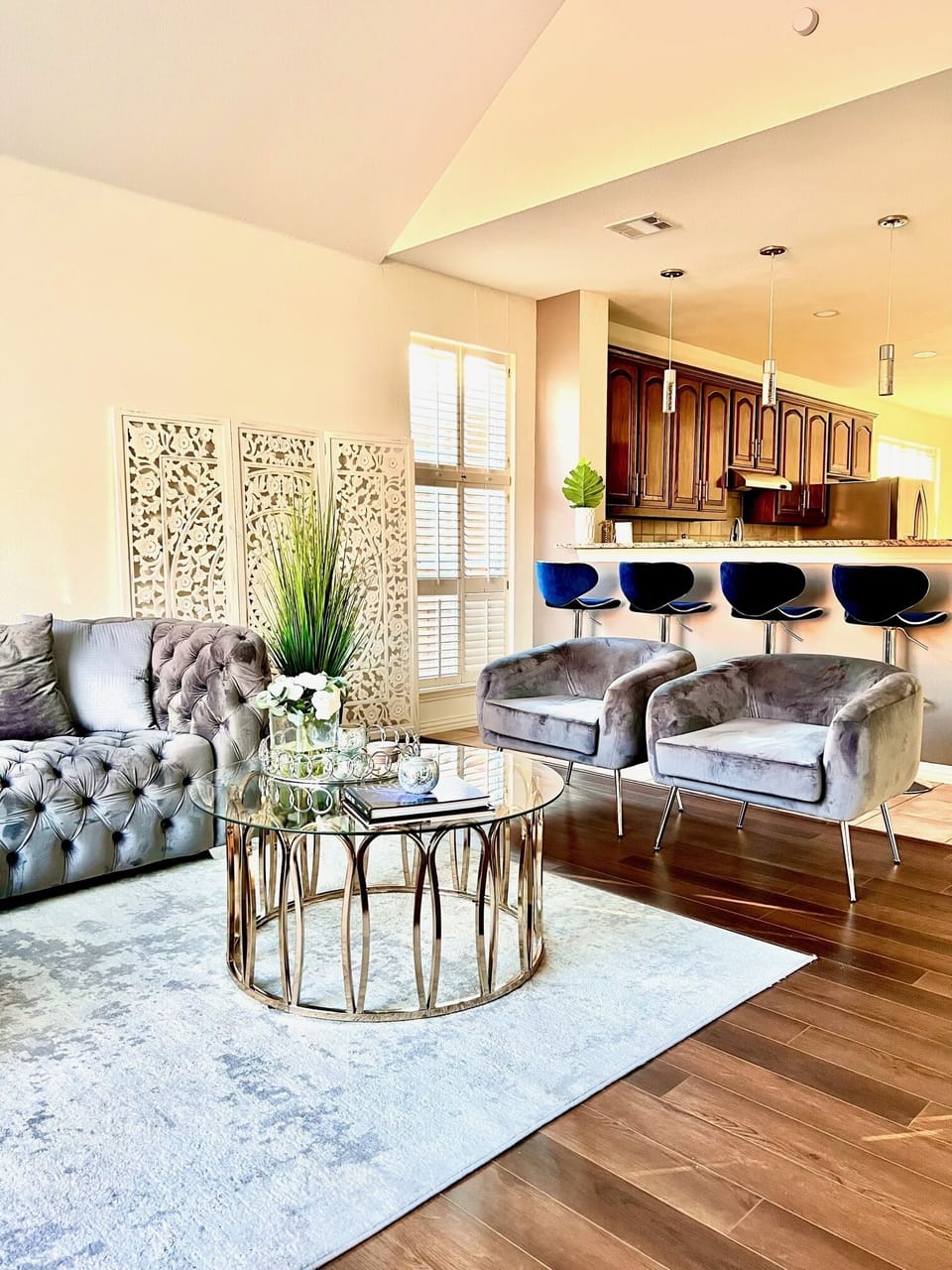 Luxurious living room features plush velvet sofas. 