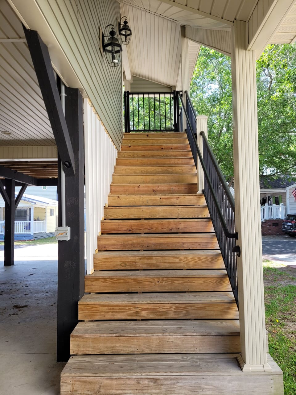 Covered Stairs leading up to the porch/balcony. There is a gate at the top.