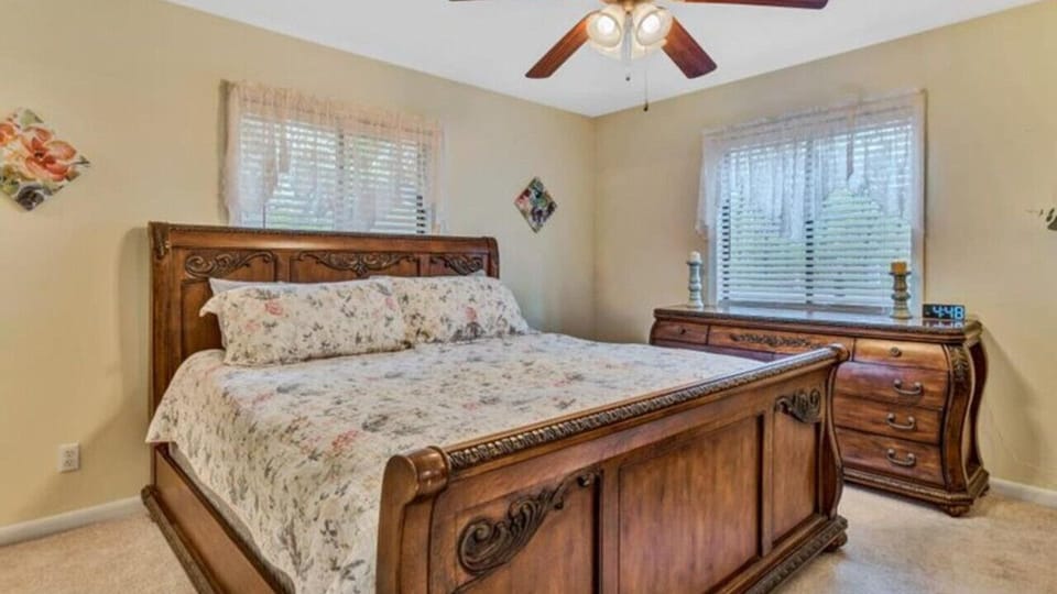 Cozy primary bedroom with efficient use of space and featuring a king bed.