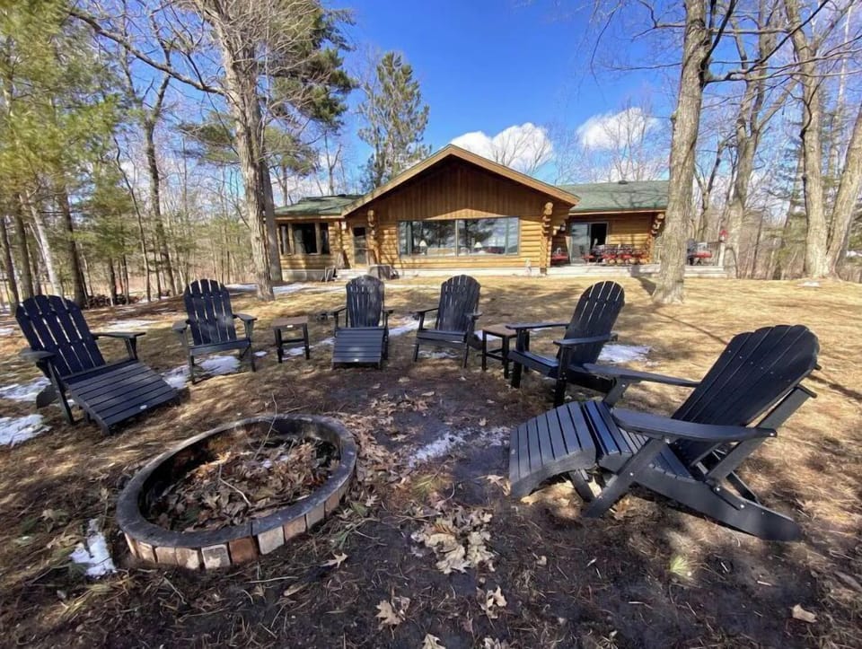 Adirondack chairs around fire pit over looking the lake: perfect for day / night