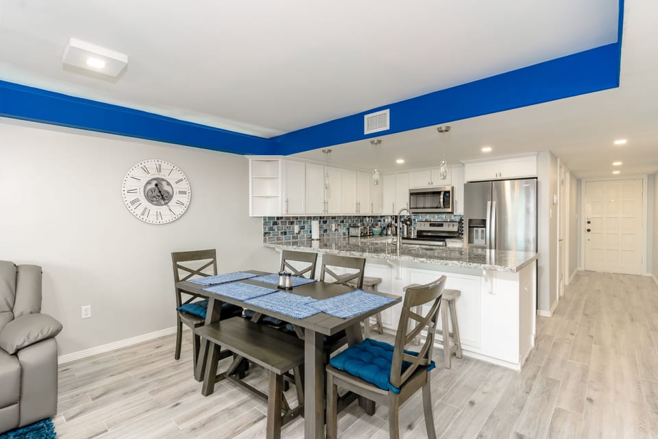 There are 4 chairs and one bench for seating at the dining table. 