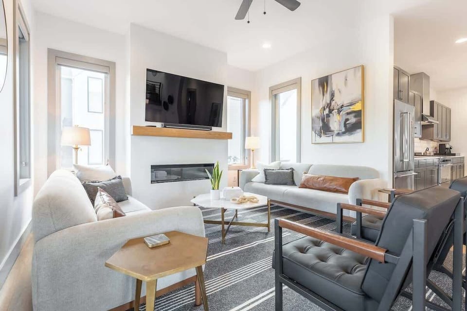 Bright and airy space with modern furnishings, a sleek fireplace, and a stunning view!