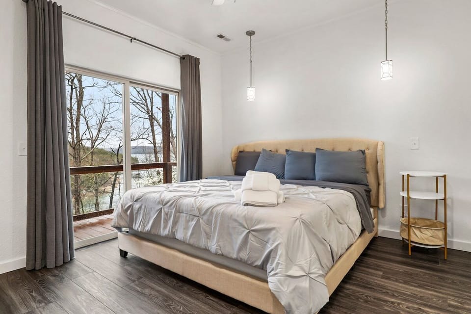 Our Master bedroom is complete with a King-size bed, closet, dresser, en suite bath and door leading out to the back patio.