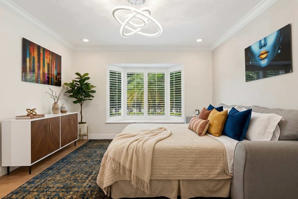 This room features a versatile sofa that effortlessly transforms into a comfortable bed