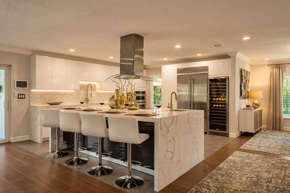The lavish chef’s kitchen with a sleek stone breakfast bar and luxe wine fridge