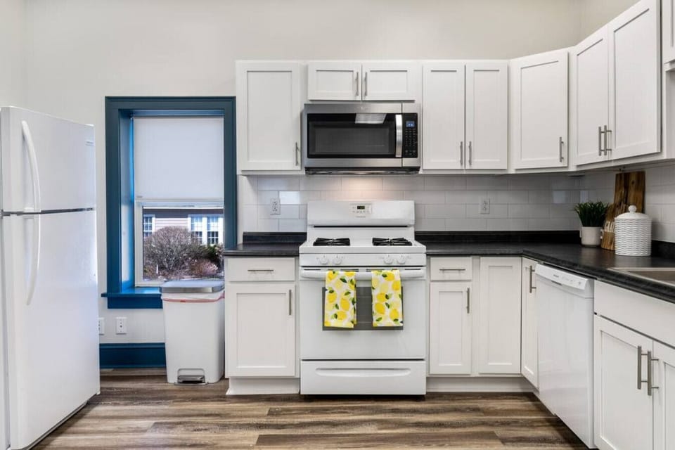 Fully stocked kitchen with dishware, cookware, and coffee/tea basics.