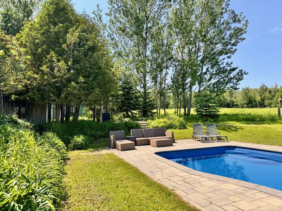 Private, solar heated pool with lounge chairs and sectional.