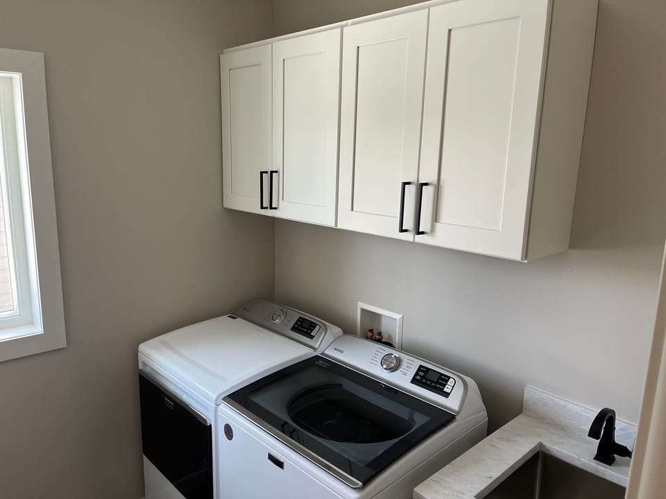 Large capacity washer and dryer and utility sink. 