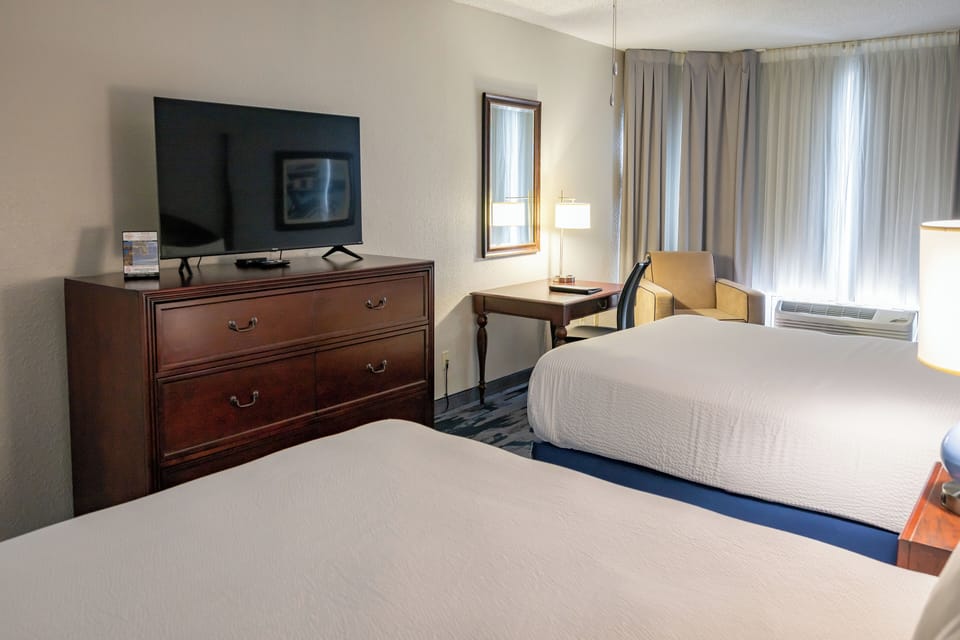 Deluxe Suite | Premium bedding, desk, laptop workspace, blackout drapes