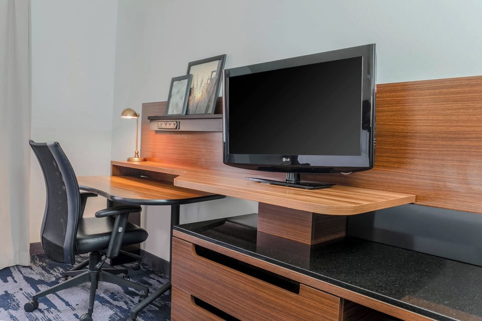 Premium bedding, desk, laptop workspace, blackout drapes
