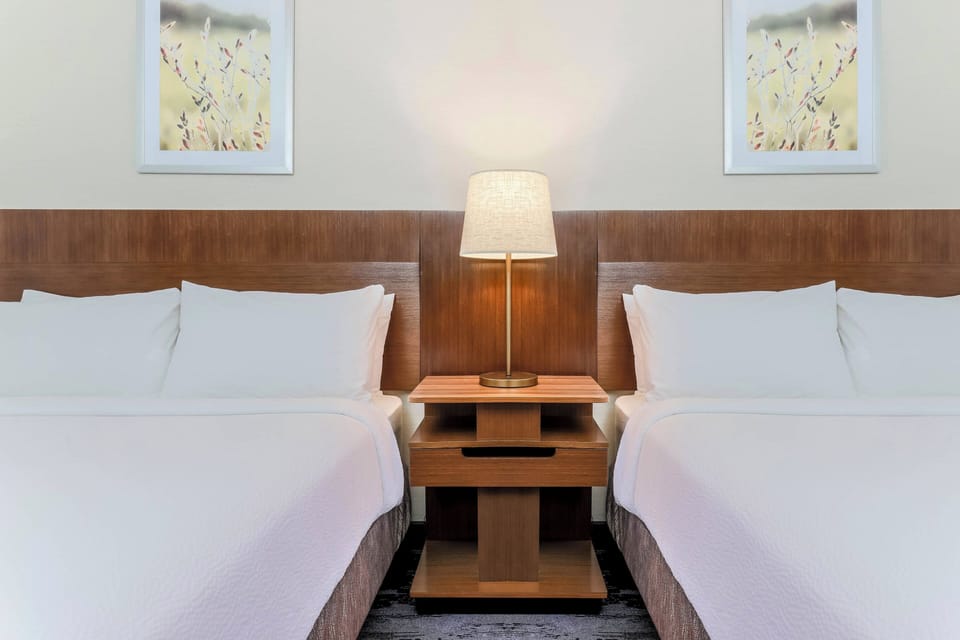 Premium bedding, desk, laptop workspace, blackout drapes