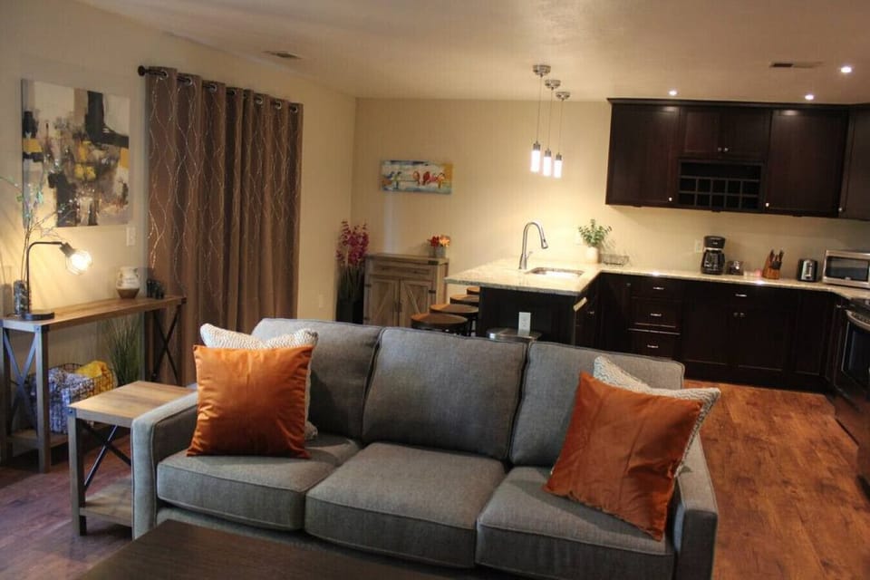 This open-concept layout creates an inviting and social atmosphere, perfect for entertaining and creating lasting memories. The living room exudes warmth and relaxation, with cozy seating arrangements and tasteful decor.