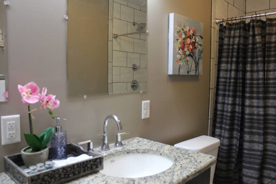 Discover convenience and elegance in our short-term rental's exquisite sink area within the bathroom. Immerse yourself in a world of style and functionality as you freshen up and prepare for the day ahead.