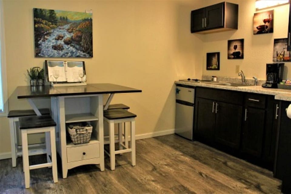 Experience the epitome of convenience and elegance in our short-term rental`s small kitchen and adjoining dining area. This harmonious space seamlessly combines functionality and style, offering a cozy haven for culinary adventures and delightful dining e