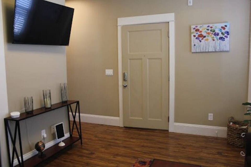 Experience the perfect blend of comfort and entertainment in our short-term rental's spacious living room, complete with a state-of-the-art TV.