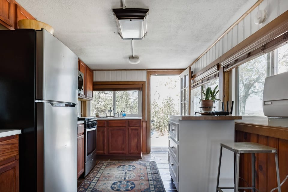 Charming kitchen with natural light, modern appliances, and a cozy rustic vibe.