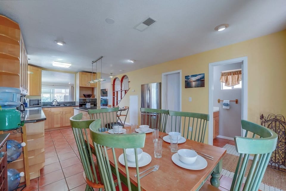 Open kitchen with view of half bathroom, dining table for 6
