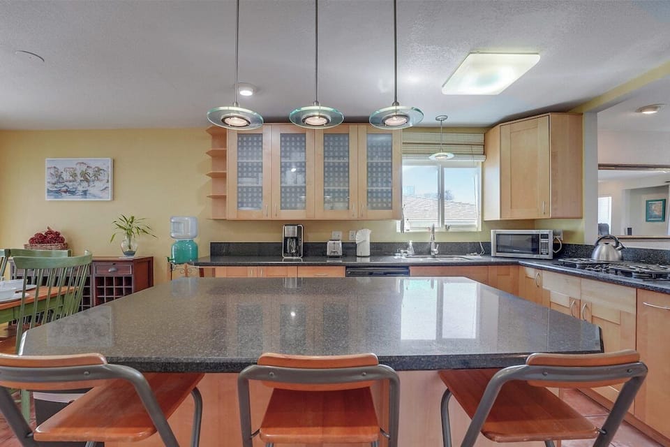 Kitchen with dishwasher, stove, oven, refrigerator, microwave, pantry storage and utensils and dishware