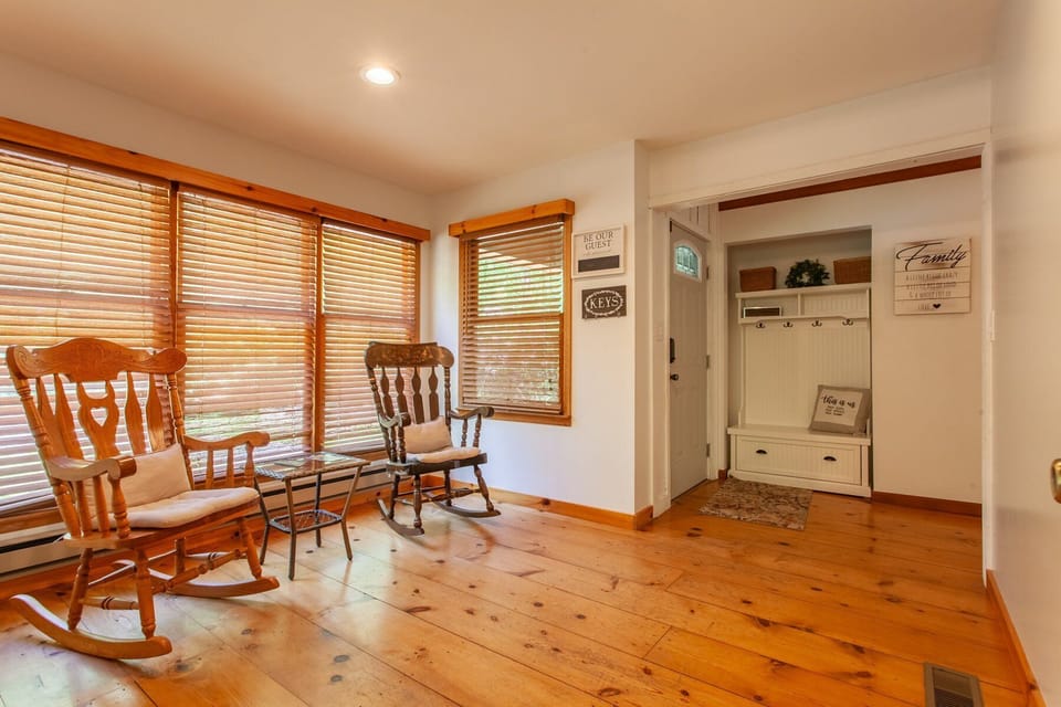 Bright, open-concept floor plan connecting the living area and dining space with hardwood floors.