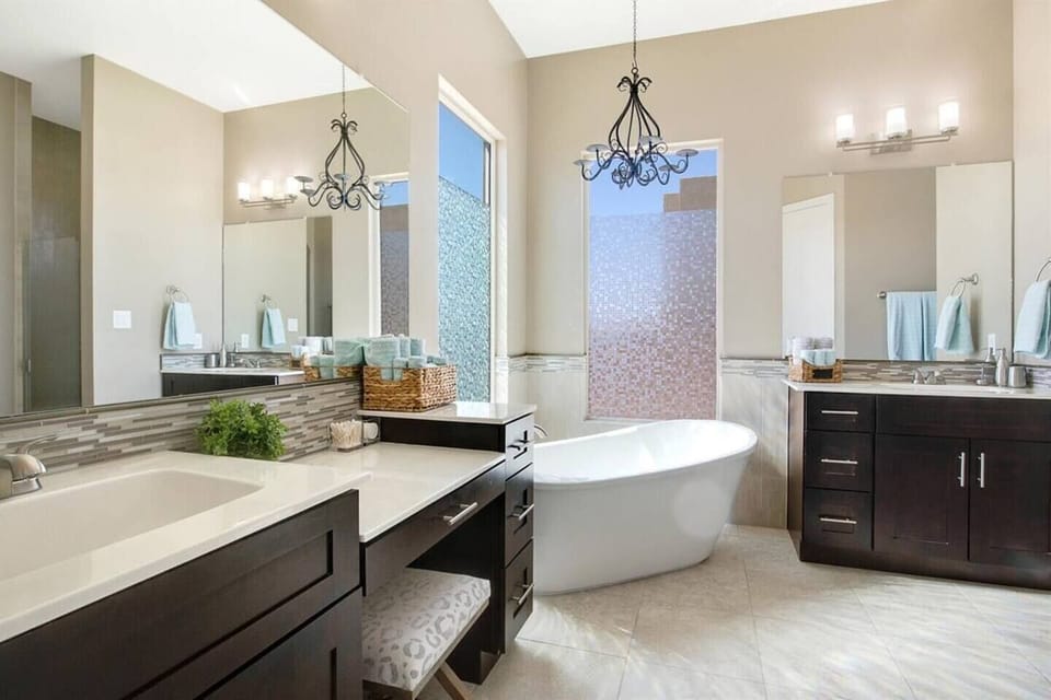 Soaking tub on main floor in main bedroom with two separate sink vanities