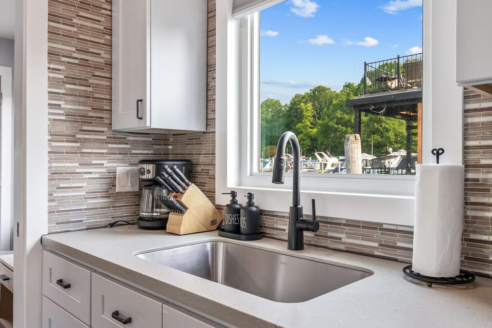 Deep stainless sink, sleek fixtures, and a full set of cooking essentials.