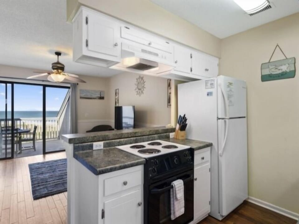Indoors, Kitchen, Ceiling Fan, Refrigerator, Cooktop