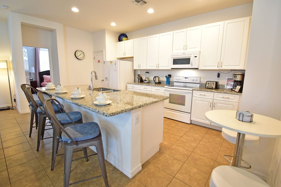 Kitchen with bar seating for 4 people and a separate breakfast table seating 2