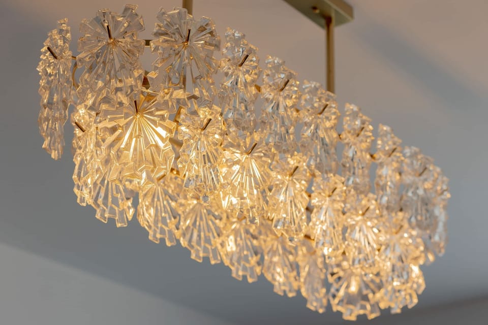 A close-up of a sparkling chandelier with crystal details, adding a glamorous touch to the interior.

