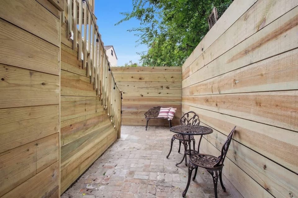 Charming private outdoor nook with classic brick flooring and café-style seating—perfect for a quiet morning coffee or evening unwind.