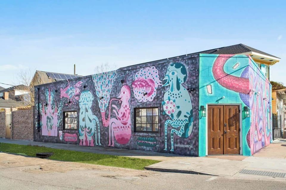 Striking mural-covered exterior spanning the entire building, featuring bold colors and local artistry. A standout, Instagram-worthy setting that reflects the vibrant culture and creativity of New Orleans.