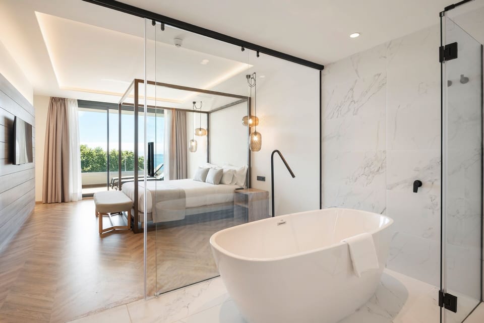 Deluxe Suite, Sea View | Bathroom | Shower, hair dryer, bathrobes, slippers