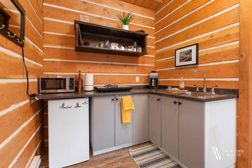 The kitchenette features a drip coffee maker, microwave, hot plate, and a toaster.