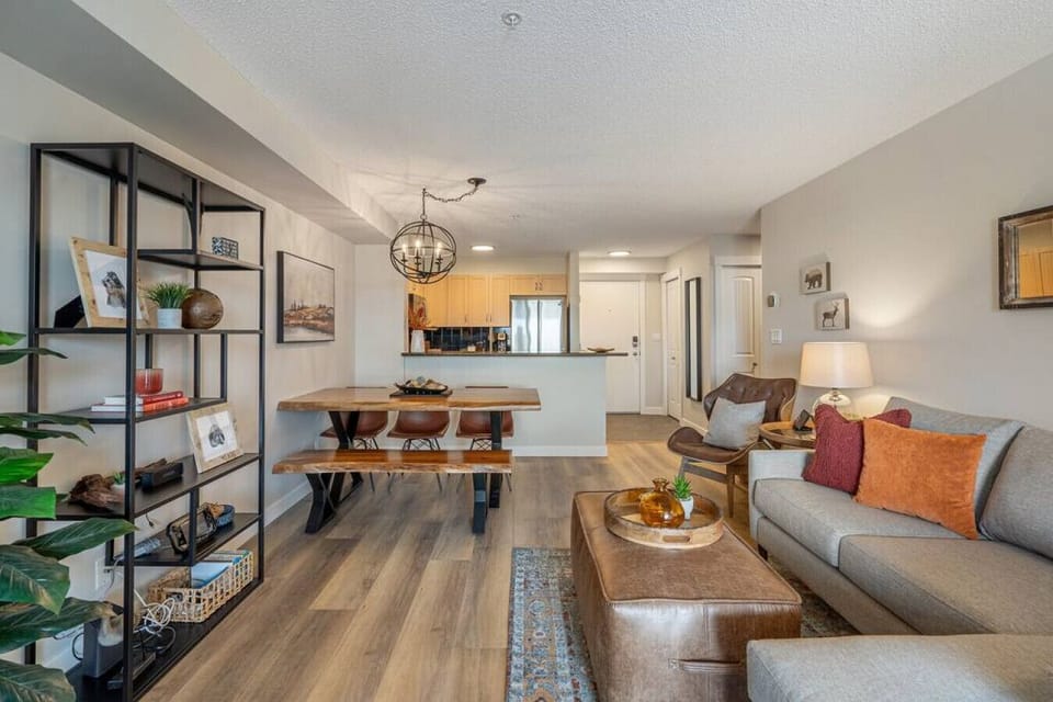 Living room with an electric fireplace, Smart TV with cable, board games, a Wii-U (with games), cozy seating options and walkout access to the balcony.